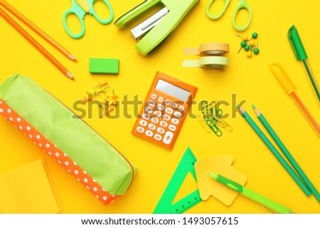 School supplies on yellow background. Minimalism concept