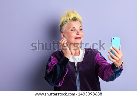 beautiful awesome woman in fashion sportswear talking with her friend by video call. spare time, leisure.