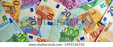 United country's payment system - euro money cash background, pile of paper euro banknotes. Banner photo.