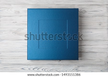 stylish designer square box for photo books...
cardboard box for a photo album.
Box for wedding album on the wooden background.
Gift box with lid.