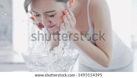 beauty asian woman wash her face in the morning Royalty-Free Stock Photo #1493154395