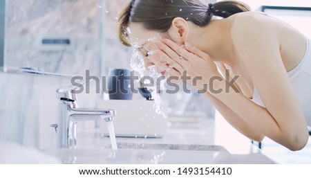 beauty asian woman wash her face in the morning Royalty-Free Stock Photo #1493154410
