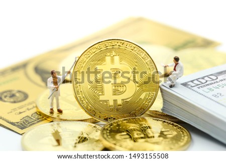 Miniature people : worker painting with Bitcoins ,credit card  of dollar banknote,Digital money cryptocurrency concept.