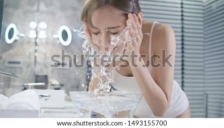 beauty asian woman wash her face at night Royalty-Free Stock Photo #1493155700