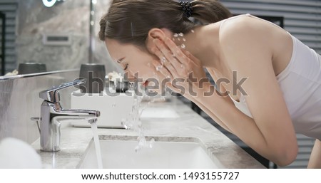 beauty asian woman wash her face at night Royalty-Free Stock Photo #1493155727