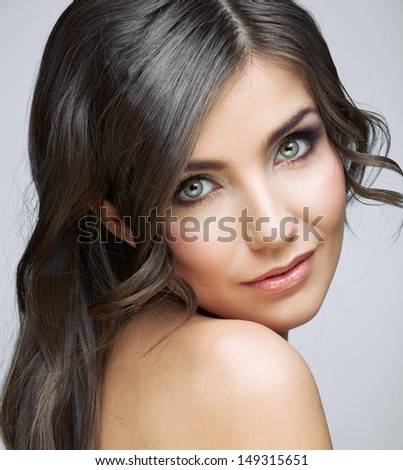 Beautiful woman with long brown hair. Female model studio portrait.