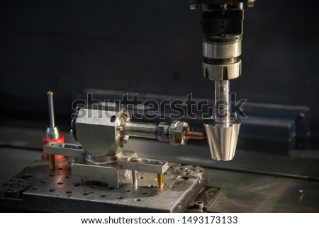 The sinker EDM machine simulation operation with the sample parts. The mould and die manufacturing process by Electrode Discharge Machine with the copper material electrode. Royalty-Free Stock Photo #1493173133
