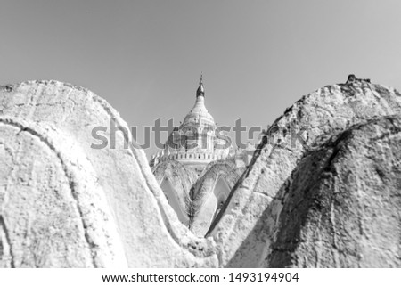 Black and white picture of amazing curves buddhist temple called  Hsinbyume Pagoda, located close to Mandalay, Myanmar