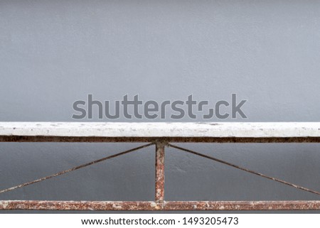 Old white wooden table with rusty steel frame on gray background