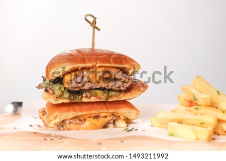 Italian burger with chess and creamy mac on wood table