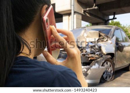 Asian woman driver making phone call after traffic car accident.