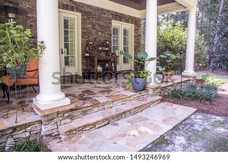 outdoor patio porch of traditional upgraded custom home with seating for entertaining and dining