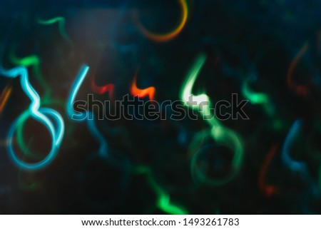 Neon aqua blue lights. Blur glowing swirly lines, rings. Dark abstract art background.
