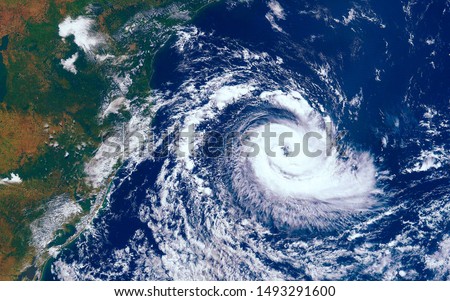 Category 5 super typhoon approaching the coast. The eye of the hurricane. View from outer space  Some elements of this image furnished by NASA Royalty-Free Stock Photo #1493291600