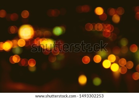 Abstract beautiful blurred colorful bokeh from ornamental lights flickering on the road with haze filter. Background for nightlife people or street night traveler concept. Bangkok Thailand. 