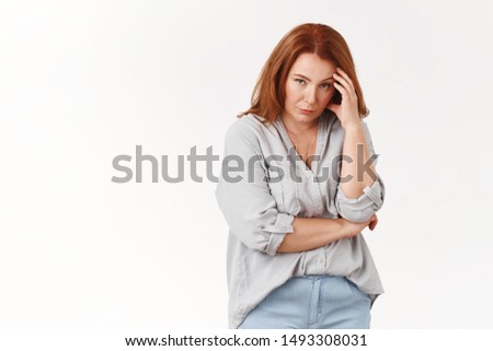Stop it. Irritated displeased annoyed redhead middle-aged pressured woman touch temple look from under forehead scorn bothered cannot stand anymore displeased intense white background Royalty-Free Stock Photo #1493308031
