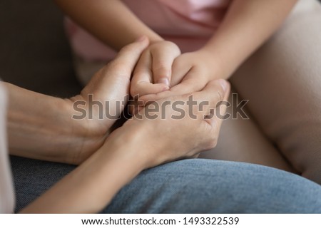 Close up image mother and daughter palms, mommy holding hands of kid, mom is always nearby, sharing mental and physical pain, concept of counsellor provides support help, heart-to-heart talk concept Royalty-Free Stock Photo #1493322539