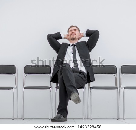 dreaming of a businessman sitting in an office corridor