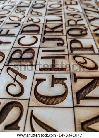 Alphabet engraved in pine plywood squares