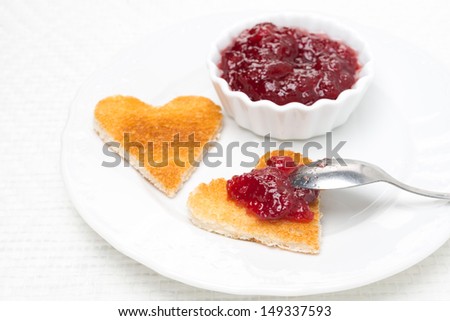 toast in the shape of hearts and berry jam on the plate, horizontal