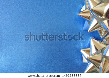 Silver decorations on shiny blue festive background, space for your design