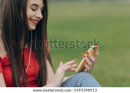Woman using app on smartphone. Beautiful young woman is using an app in her smartphone device to send a text message Royalty-Free Stock Photo #1493398913