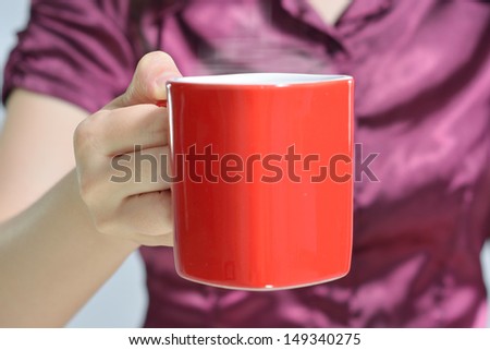 woman offering a cup of coffee