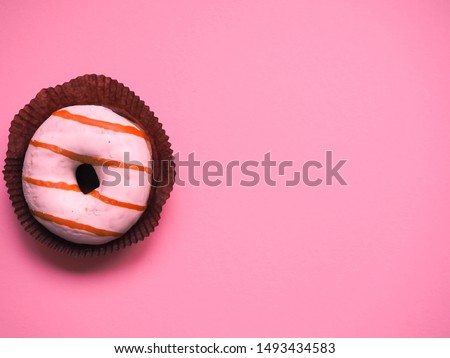 glazed donut lies on a monophonic background