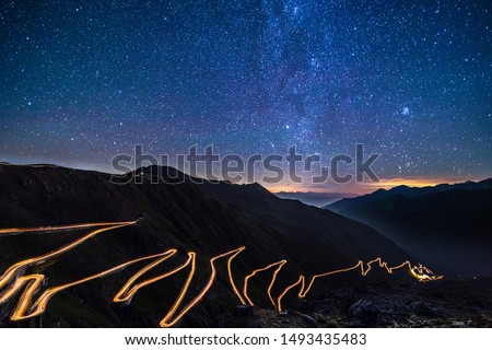 Passo dello Stelvio - Stelvio pass in Italy, Ortler Alps, Italy - curvy road through mountains at night with starry sky Royalty-Free Stock Photo #1493435483