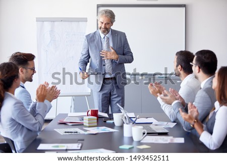 Senior businessman having a speech by a whiteboard during a conference business meeting  in an office. Business concept Royalty-Free Stock Photo #1493452511
