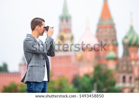 Tourist man taking a city photoof Kremlin in Moscow