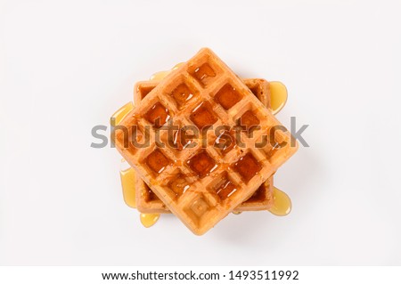 Fresh waffles with honey isolated on white background.Top view Royalty-Free Stock Photo #1493511992