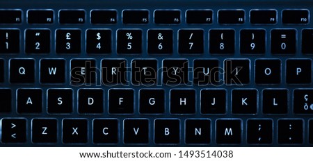 Closeup of laptop keyboard illumination, backlit keyboard. Concept Technology