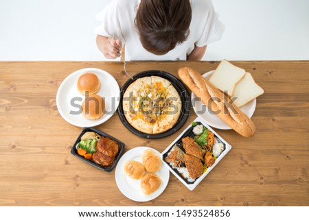The Asian woman who eats junkfood Royalty-Free Stock Photo #1493524856