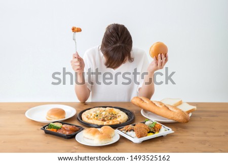 The Asian woman who eats junkfood Royalty-Free Stock Photo #1493525162