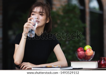 Asia woman  drinking water after tired from working with  freshness and happy.