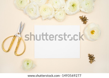 Blank note and flower feminine flat lay floral background with white lysianthus and ranunculus