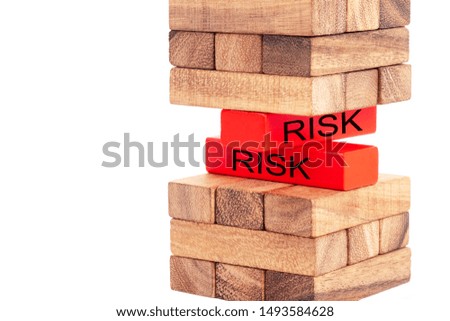 Woman hand holding  risk word on red block from stacked wooden block on white background. Symbol of leadership, teamwork and different. Business and design concept.