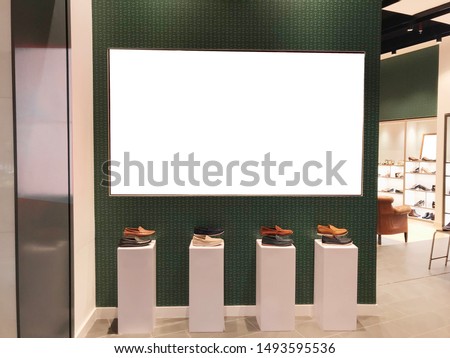 Large landscape light box digital signage in front of shoe retail store