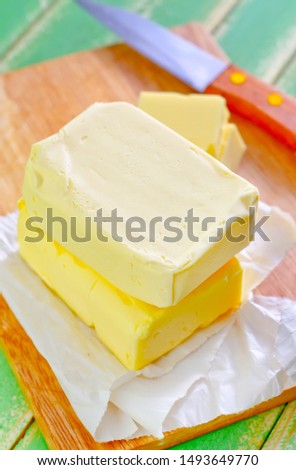 butter on white paper on board