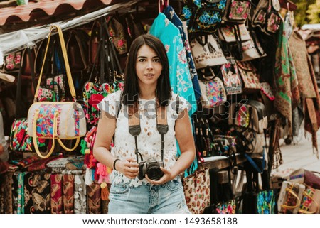 Hispanic girl Making pictures with travel camera in a Mexico trip, summer vacations in latin america