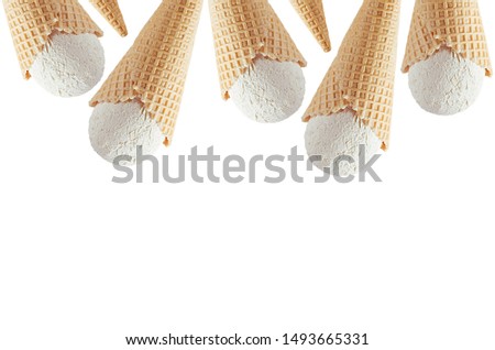 Summer food border of  white creamy ice cream in crisp waffle cones isolated on white background, copy space.