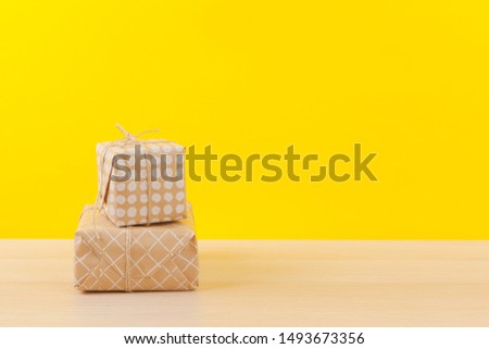 Gifts with ribbons on bright yellow background