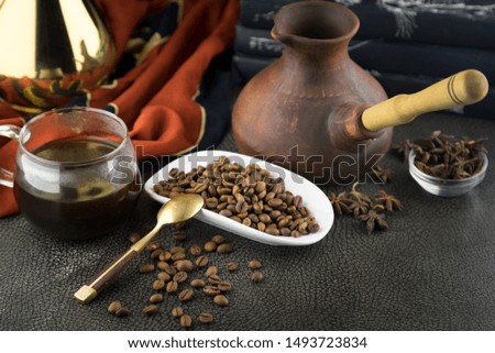 coffee beans, in a cup, with a teapot