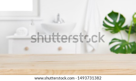 Wood tabletop on blur bathroom background, design key visual layout Royalty-Free Stock Photo #1493731382