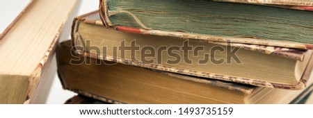 Panoramic picture of stacked antique very old books