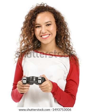 African-American teenage girl playing video game on white background