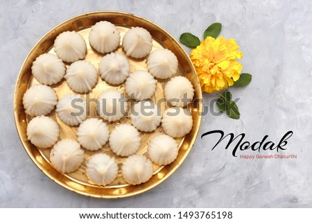 Steamed or ukdiche Modak - a traditional sweet dish made out of coconut, jaggery and dry fruits stuffed inside rice dough on Ganpati festival in India. with copy space Royalty-Free Stock Photo #1493765198