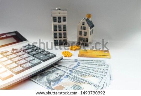Banknote dollar, calculator and credit card are important in calculate saving for homeowner, repair, expand, leasing or transactions such as refinance, mortgage, decrease interest or debt restructure.