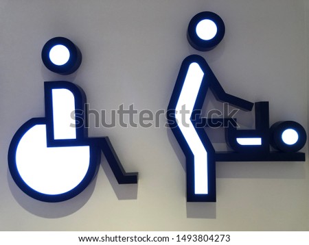 Signs and symbols: male and female toilet, for the disabled. A sign indicating the place for changing clothes for children and a public toilet. Illuminated sign in the mall, symbol for the toilet.